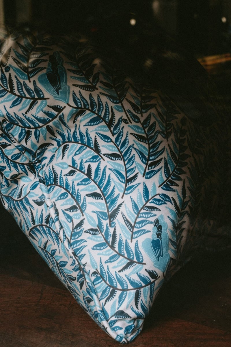 blue pillow with floral pattern