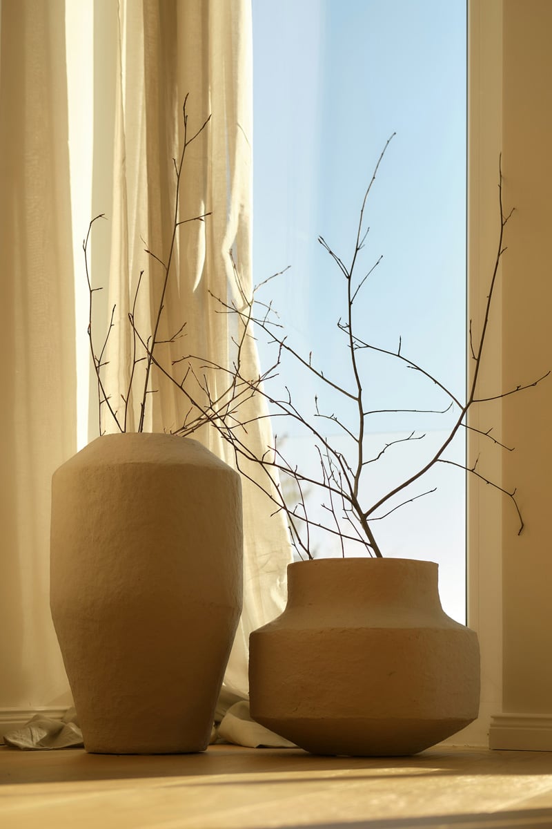 beige curtains and vases