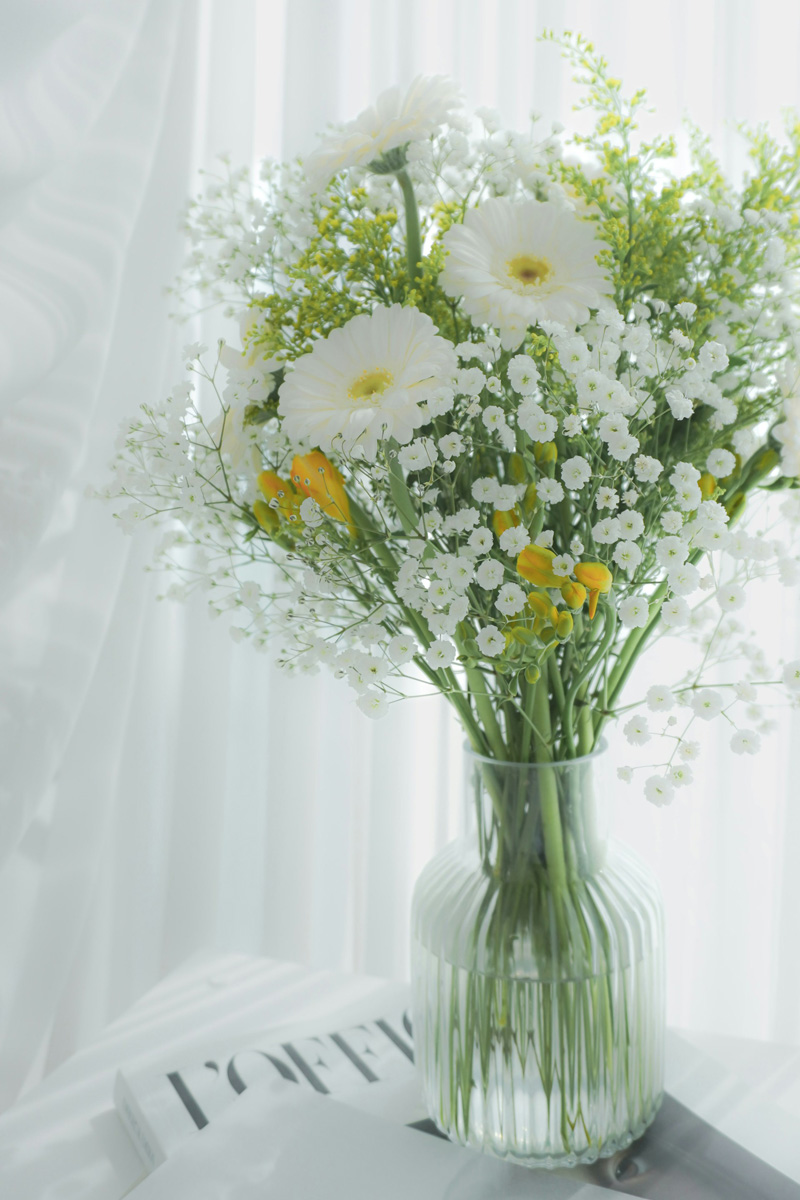 vase of flowers and sheer white curtains