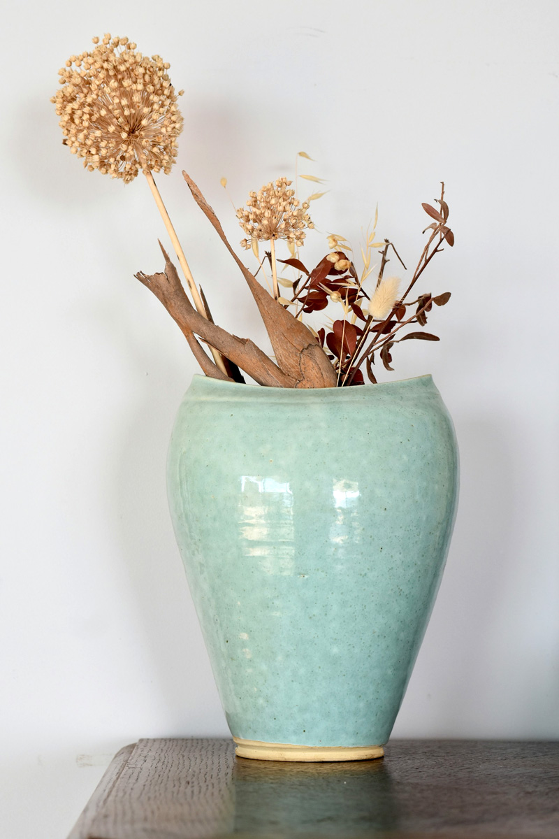 dried flowers and branches in a vase